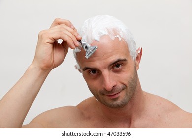 Young Man Shaving His Head
