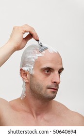 Young Man Shaving His Head