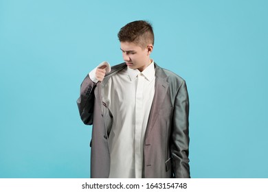 Young Man In A Shirt And Jacket Of An Adult. Obviously The Clothes Are Too Big For The Guy