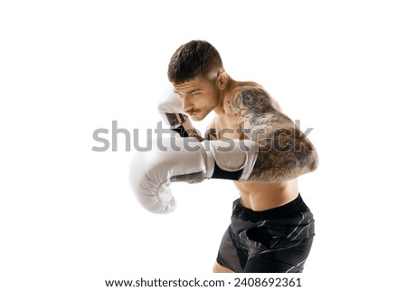 Young man, shirtless boxing athlete with muscular body training, punching isolated over white background. Concept of professional sport, combat sport, martial arts, strength