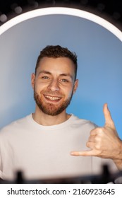 Young Man Shoots A Video On A Phone With A Ring Lamp, Portrait In Color Light