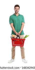 Young Man With Shopping Basket Full Of Products Isolated On White