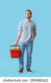 Young Man With Shopping Basket On Color Background