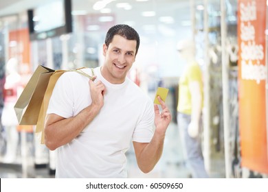 A Young Man With The Shopping And Credit Card At The Store