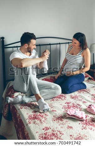 Image, Stock Photo Man showing baby clothes to pregnant woman