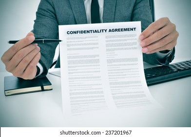 A Young Man Showing A Confidentiality Agreement Document