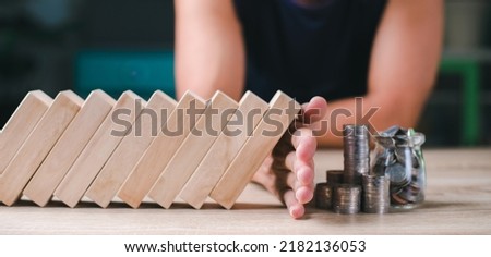 Young man showing defense, finance, investment by blocking a stick. which is like risk, crisis, bankruptcy, change Keep the coin pile safe. Savings Ideas and Strategies That Are Safe for Businesses