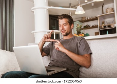 Young Man Showing Gesture In Sign Language Using Laptop, Make Video Call.