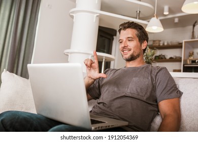 Young Man Showing Gesture In Sign Language Using Laptop, Make Video Call.