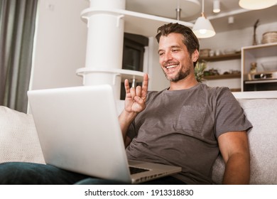 Young Man Showing Gesture In Sign Language Using Laptop, Make Video Call.