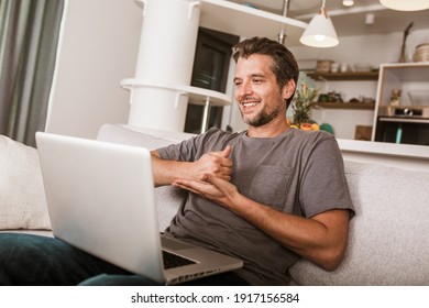 Young Man Showing Gesture In Sign Language Using Laptop, Make Video Call.