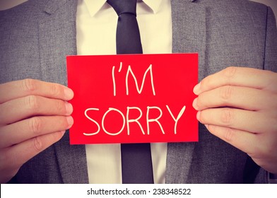 a young man showing a red signboard with the text I am sorry written in it - Shutterstock ID 238348522