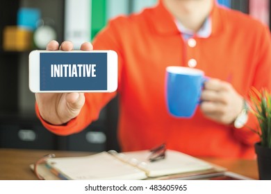 Young Man Showing Smartphone And INITIATIVE Word Concept On Screen