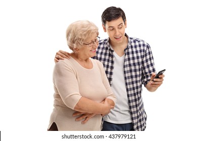 Young Man Showing Something To An Elderly Woman On His Cell Phone Isolated On White Background