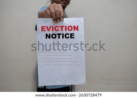 young man shows a document with the text eviction notice