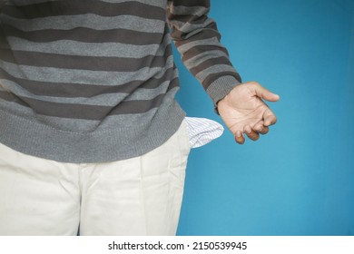 Young Man Shows Empty Pant Pocket With Copy Space 