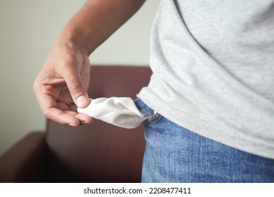 Young Man Shows Empty Pant Pocket With Copy Space 