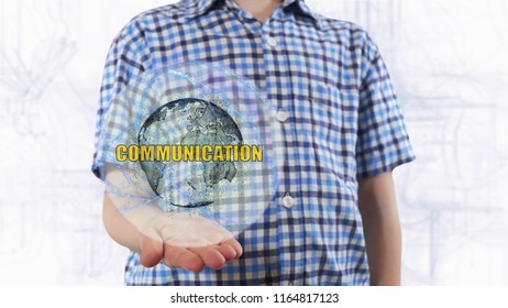 Young man shows a hologram of the planet Earth and text Communiccation. Boy with future technology 3d projection on a modern white digital background - Powered by Shutterstock - Get 15% off with code: PIKWIZARD15