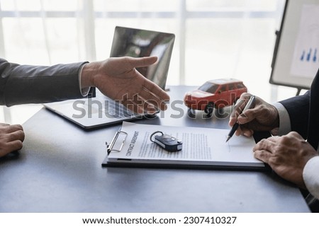 Young man signing car insurance or rental documents Transportation finance cost management planning Concept of auto insurance business