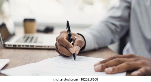 Young Man Signing An Official Document, Male Hand Holding Pen Putting Signature At Paper Contract Agreement. Business, Lawyer, Finance, Notary, Trading, Loan, Work Place, Accounting Concept