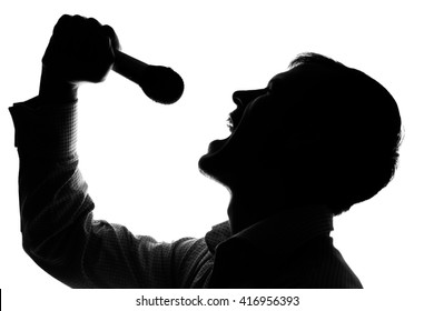 A Young Man Singing Into A Microphone - Silhouette