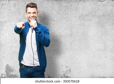 Young Man Singing With A Microphone