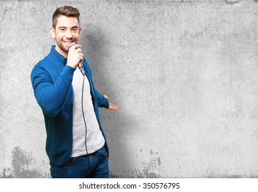 Young Man Singing With A Microphone