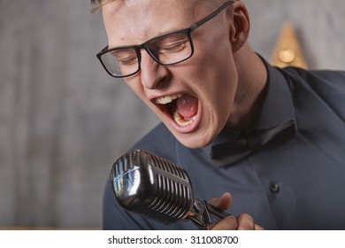 Young Man Singing With Vintage Microphone
