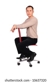 Young Man Sits On Red Chair Sideview