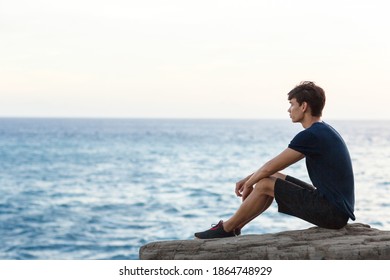 Young Man Sitting Alone On Cliff Stock Photo 1864748929 | Shutterstock