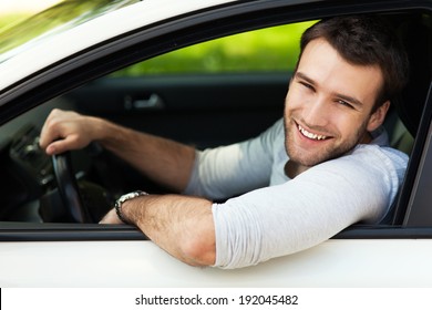 Young Man Sitting In A Car 