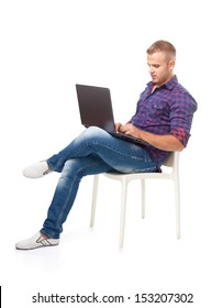 Young Man Sitting In Chair And Working On Laptop Computer Isolated On White Background