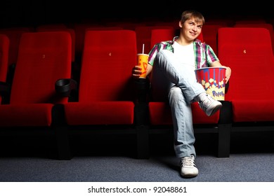 Young Man Sitting In Cinema And Watching Movie