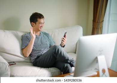 Young man sitting comfortably with laptop searching hotel accommodations online  trying to save on hotel stays  booking a room  checking out a selection of resorts