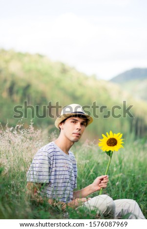 Similar – young man with hat in front of mountain panorama