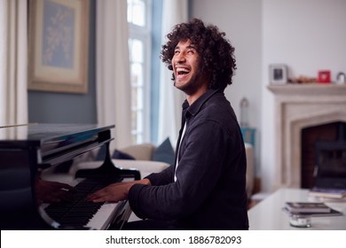 Young Man Sitting At Grand Piano And Playing At Home - Shutterstock ID 1886782093