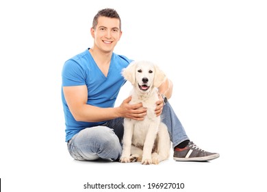 Young Man Sitting With His Dog On The Floor Isolated On White Background