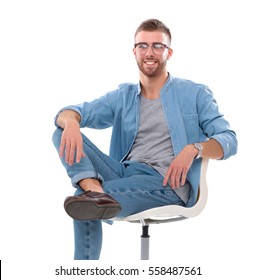 Young Man Sitting On The Chair Isolated Over White Background