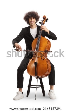 Young man sitting on a chair and playing a cello isolated on white background