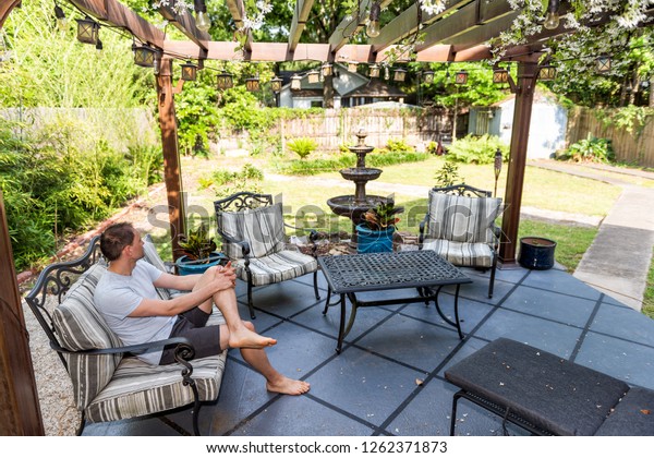 Young Man Sitting On Patio Lounge Stock Photo Edit Now 1262371873