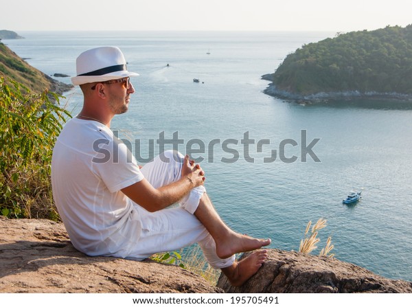 Young Man Sitting On Rock Looking Stock Photo (Edit Now) 195705491