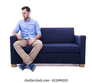 Young Man Sitting On Sofa Isolated On White Background