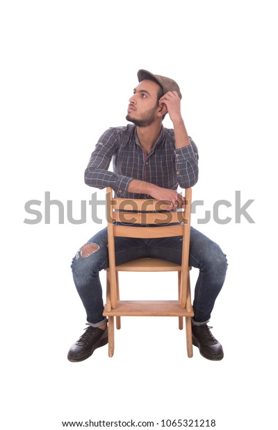 Young Man Sitting On Wooden Chair Stock Photo Edit Now