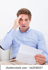 Young Man Sitting Sofa Shocked Reading Stock Photo 162930557 | Shutterstock