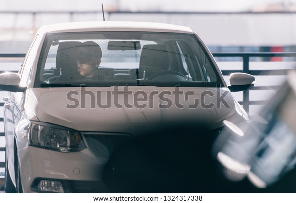 Young man is sitting in\
the stolen car