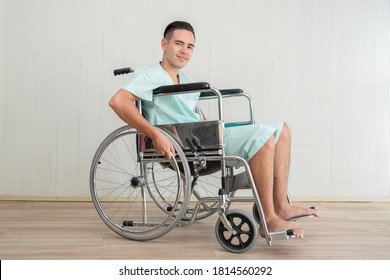 Young Man Sitting In Wheelchair At Hospital 