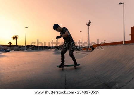 Similar – teenager practicing with skateboard at sunrise city