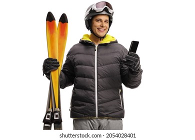 Young man with skiis smiling and holding a mobile phone isolated on a white background