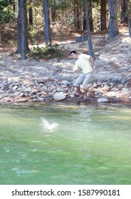 A Young Man Skimming Stones