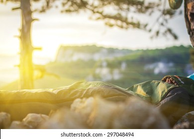 Young Man Sleeping In Sleeping Bag In The Mountains